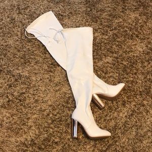 Never worn, thigh high white boots w/ accent heel
